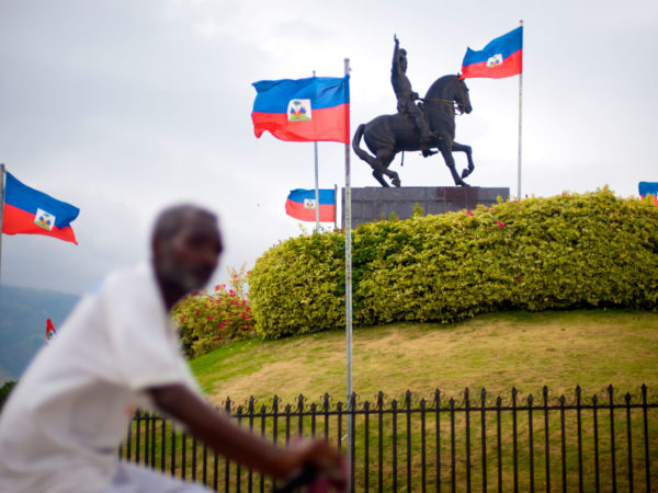 BC03TC A bicyclist passes a monument to Jean Jacques Dessalines in the Champ de Mars plaza, Port-au-Prince, Haiti.